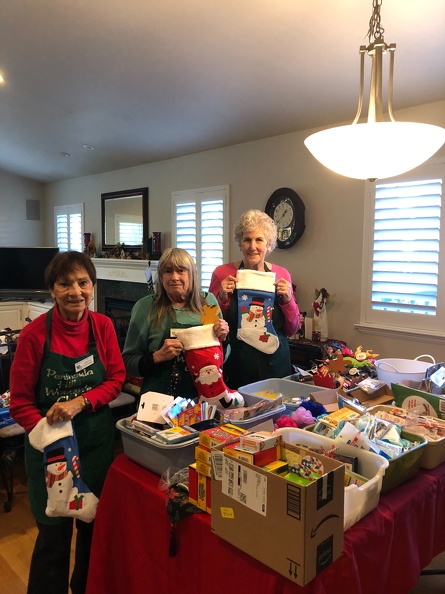 Arcie, Pat & Carol stuffing stockings.jpeg